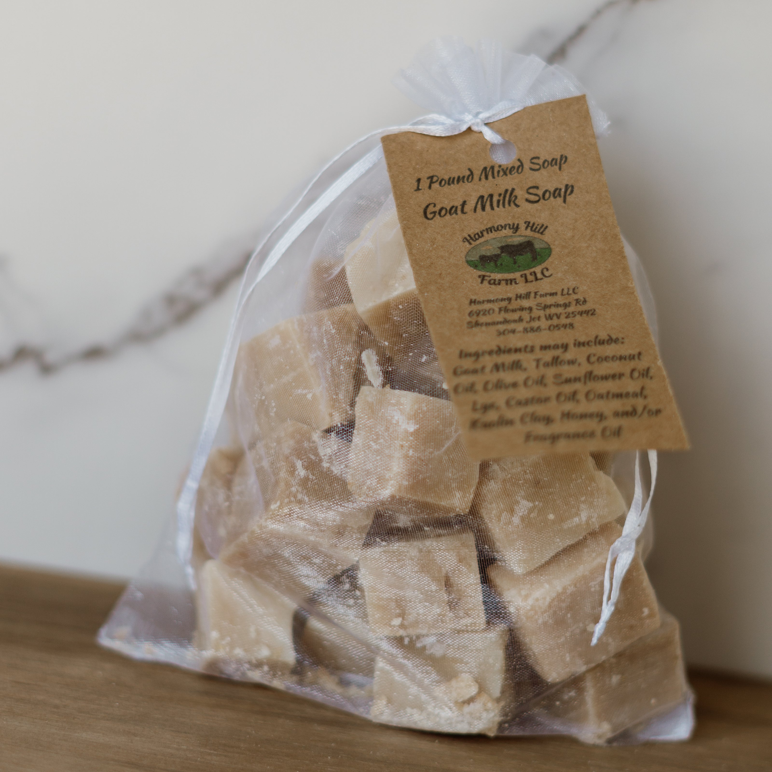 Bag of goat milk soap with a label on a wooden surface