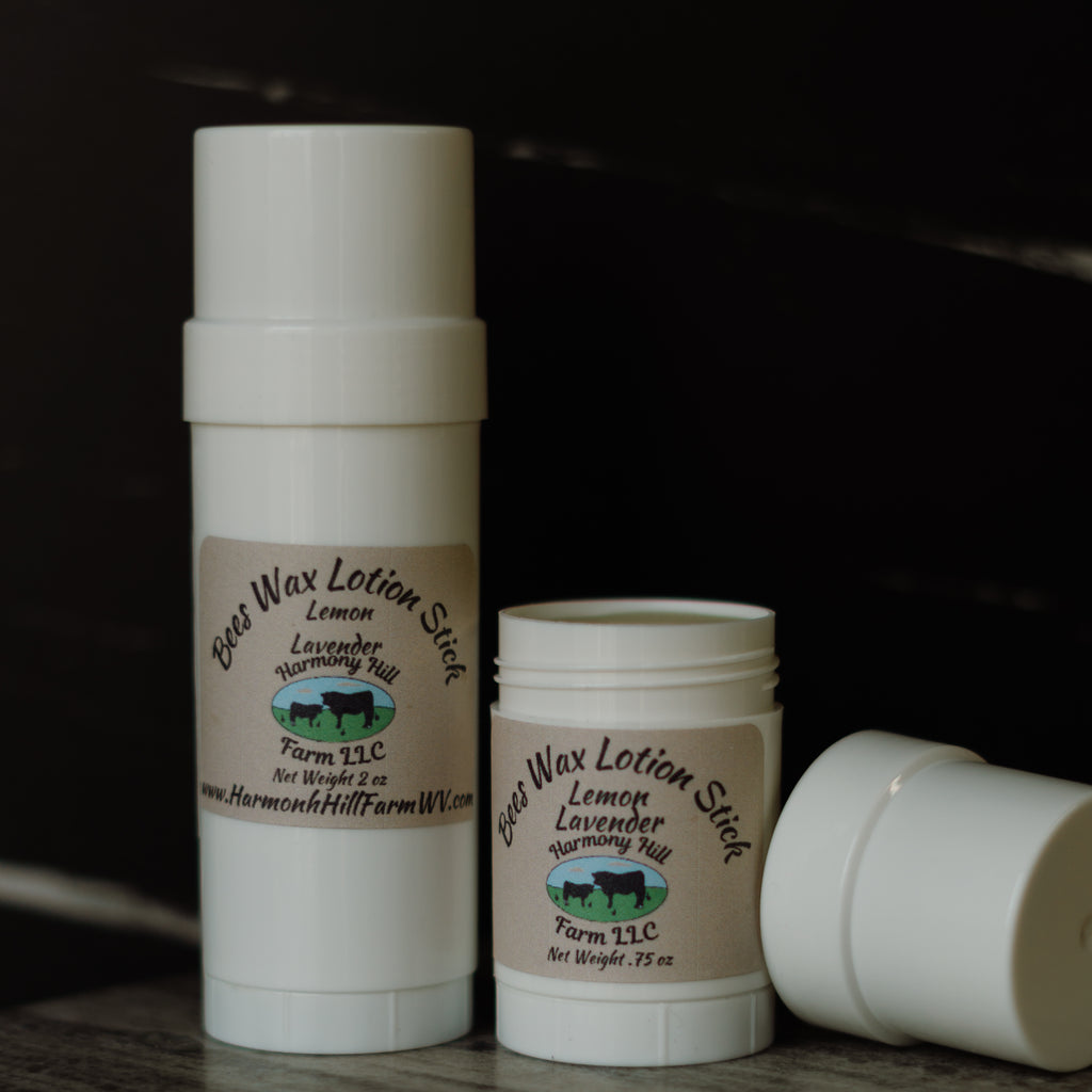 Two containers of Bee Wax Lotion Stick from Harmon Hill Farm LLC on a dark background