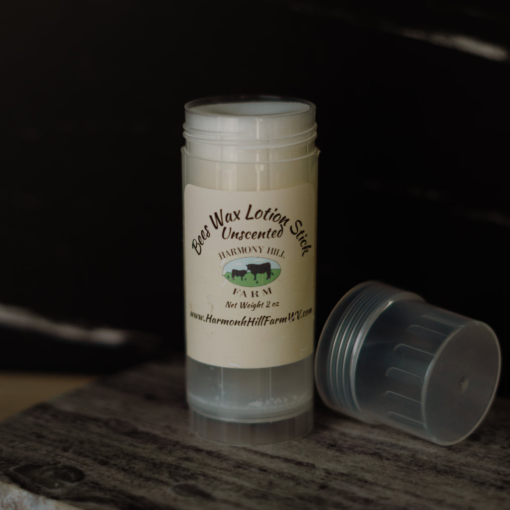 Beeswax lotion stick with a label on a dark background