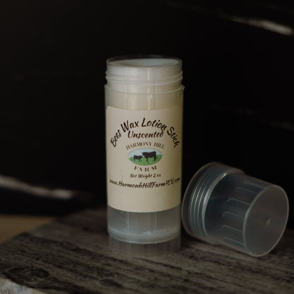 Beeswax lotion stick with a label on a dark background