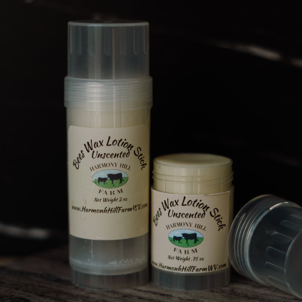 Two containers of Bees Wax Lotion Stick from Harmony Hill Farm on a dark background